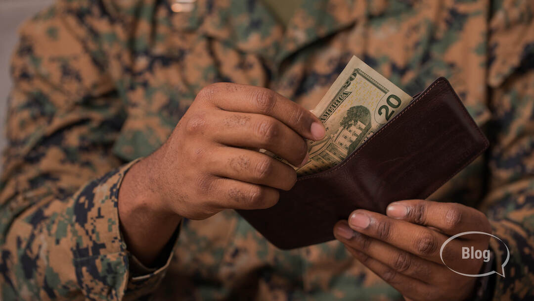 Military Service member taking $20 out of his wallet Military Service member taking $20 out of his wallet